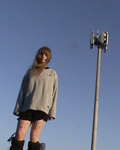 picture of Nina and a cell tower, a very prominent feature throughout ILMC especially in the 'Infohazard' music video