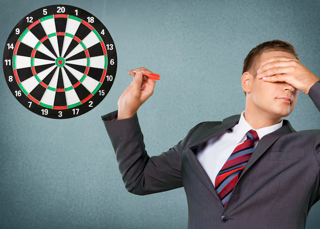 Guy looking away at a dartboard trying to hit it